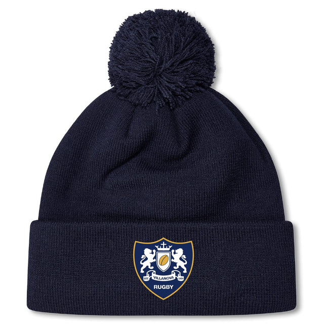 The Villanova Rugby Club Pom Pom Beanie by EMB Canterbury features a cozy navy knit, an embroidered club crest on the front cuff, and a playful pom pom on top.