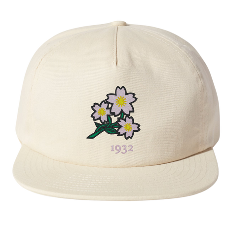 The Nations of Rugby Japan Vintage Brushed Cotton Cap by EMB Weld features embroidered white flowers with yellow centers and green stems above the number "1932.