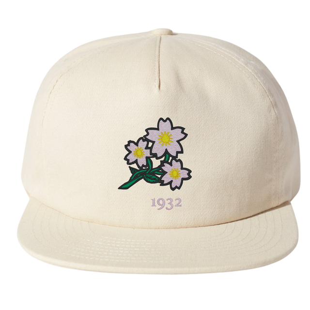 The Nations of Rugby Japan Vintage Brushed Cotton Cap by EMB Weld features embroidered white flowers with yellow centers and green stems above the number "1932.