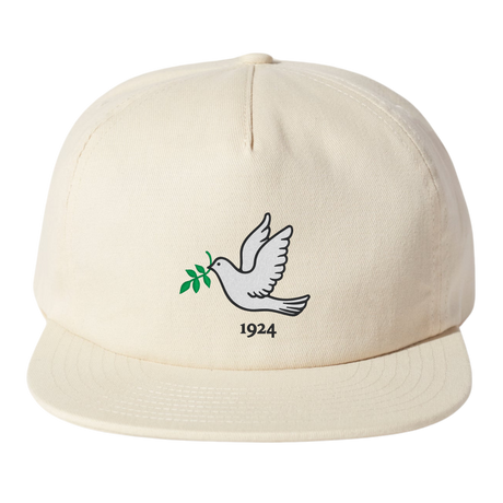 The EMB Weld Nations of Rugby Tonga Vintage Brushed Cotton Cap is crafted from brushed cotton twill in a cream color. It features a white dove graphic holding a green branch, with "1924" inscribed below, capturing the timeless spirit of the collection.