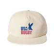 The USA Rugby Throwback Brushed Cotton Cap by EMB Weld is a beige cap made from brushed cotton twill, showcasing "USA RUGBY" and a blue eagle logo on the front, perfect for rugby enthusiasts.