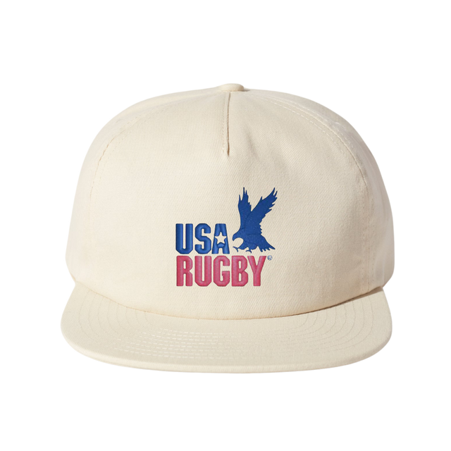 The USA Rugby Throwback Brushed Cotton Cap by EMB Weld is a beige cap made from brushed cotton twill, showcasing "USA RUGBY" and a blue eagle logo on the front, perfect for rugby enthusiasts.