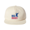The USA Rugby Throwback Brushed Cotton Cap by EMB Weld is a beige cap made from brushed cotton twill, showcasing "USA RUGBY" and a blue eagle logo on the front, perfect for rugby enthusiasts.