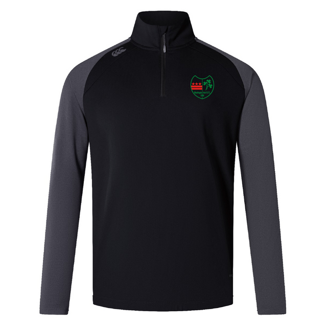 Explore the Washington Irish Rugby Elite 1/4 Zip Top by Canterbury, a black and gray long-sleeve sports top adorned with a green and red embroidered shield logo on the chest. Crafted by EMB Canterbury for performance and comfort, this top utilizes sustainable materials to enhance your workout experience responsibly.