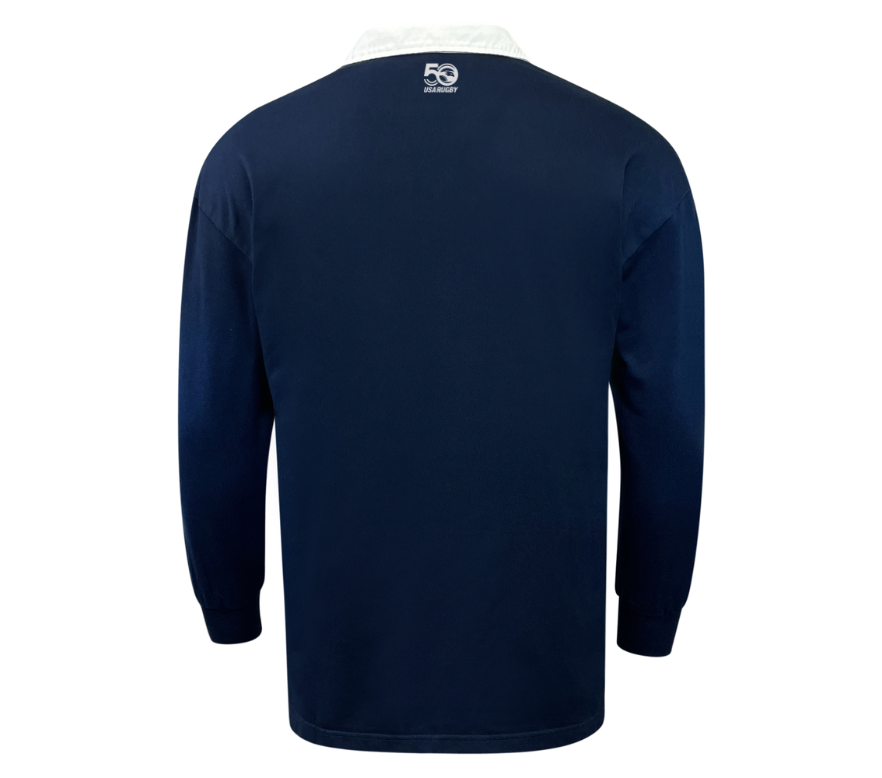 The EMB Mudoo USA Rugby Heritage 50th Anniversary Classic Jersey is a navy long-sleeve rugby shirt with a white collar, featuring a small "50 years" logo centrally placed on the back neckline to celebrate USA Rugby's legacy.