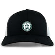 The Woodlands Youth Retro Trucker Cap by EMB S&S Activewear features a black and white design, a circular "Woodlands Rugby" paw print embroidery on the front, and an adjustable snapback closure.
