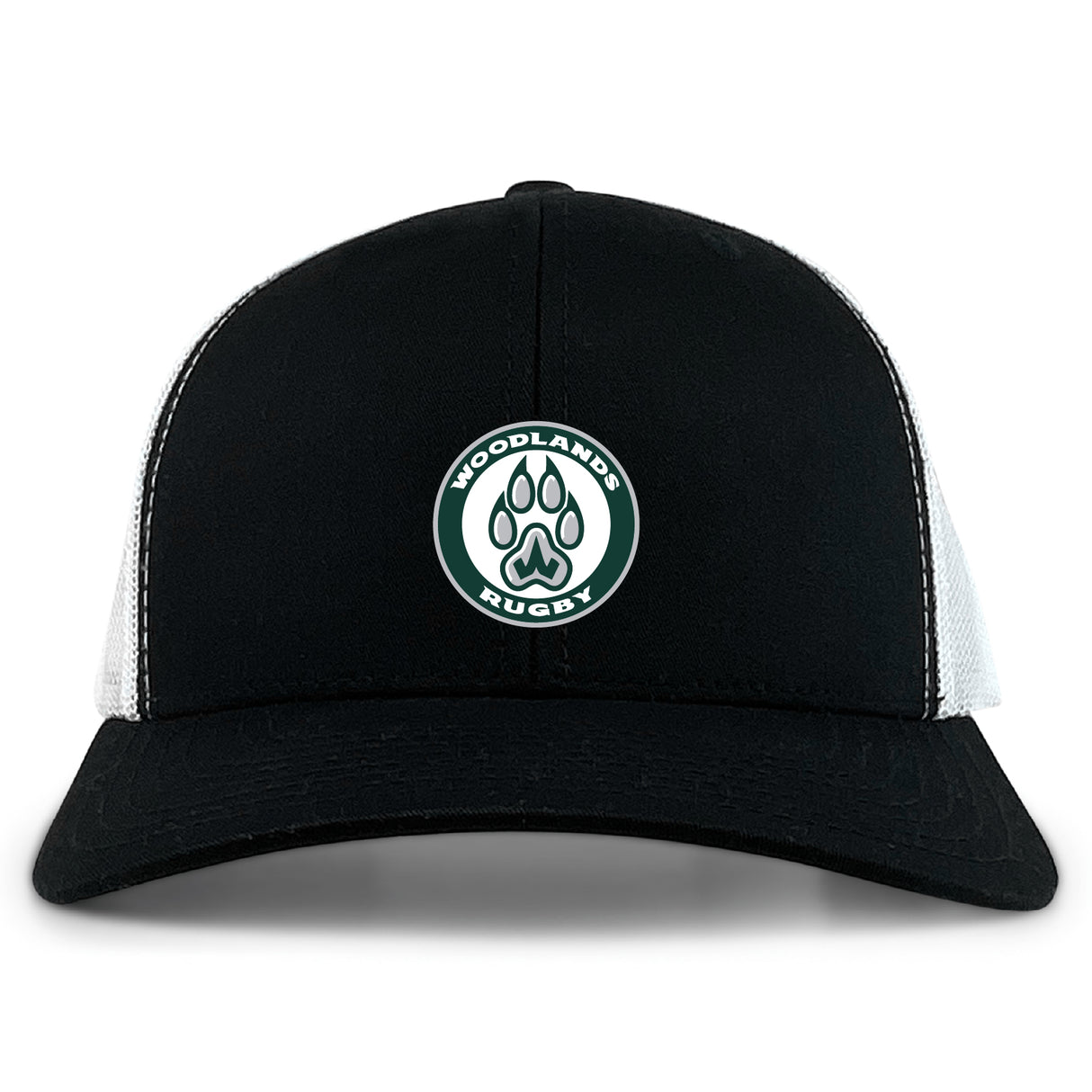 The Woodlands Youth Retro Trucker Cap by EMB S&S Activewear features a black and white design, a circular "Woodlands Rugby" paw print embroidery on the front, and an adjustable snapback closure.