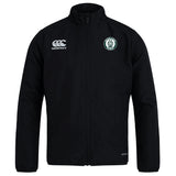 The Woodlands Youth Club Track Jacket by EMB Canterbury is a lightweight black jacket with long sleeves, featuring the Canterbury logo on the right chest and a circular green and white emblem on the left chest.