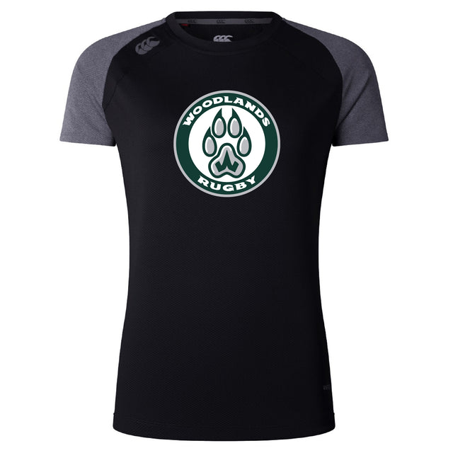 The Woodlands Youth Women’s Elite Training Tee by WRS Canterbury is a black and dark gray breathable athletic top featuring a "Woodlands Rugby" logo with a paw print on the chest.