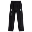 Woodlands Youth Cuffed Hem Stadium Pant by EMB Canterbury features an elastic waistband, cuffed hem, white Canterbury branding, and a circular green and white logo on the left thigh.
