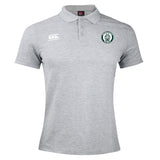 The Woodlands Youth Waimak Polo by EMB Canterbury is a light gray short-sleeve polo with a button collar, featuring the Canterbury logo on the right chest and a circular green, white, and black emblem on the left.