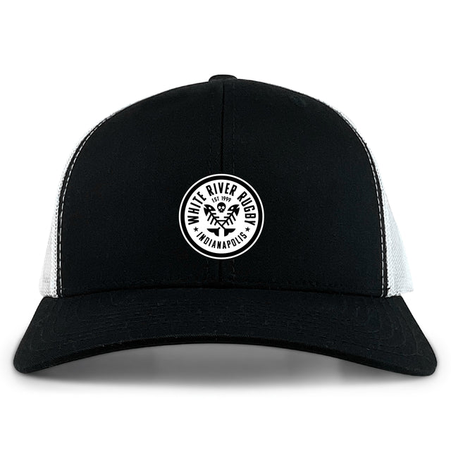 The EMB S&S Activewear White River Rugby Football Club Retro Trucker Cap features a black and white design, a circular embroidered front logo, and an adjustable snapback closure for a custom fit.