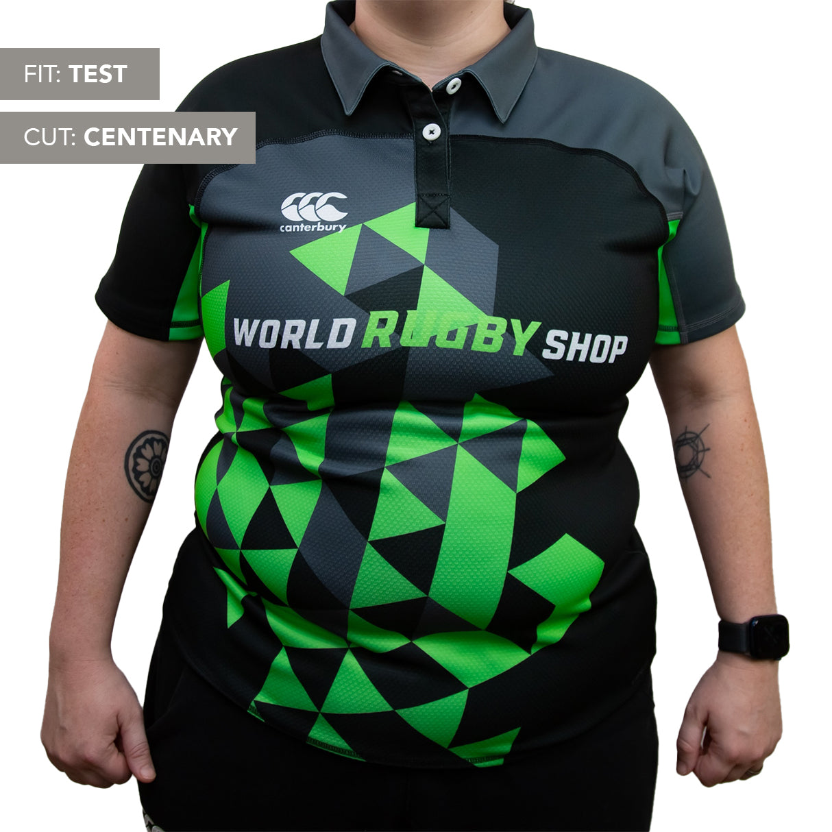 A woman wears the Teamatical Canterbury Elite Full Custom Sublimated Jersey, featuring black, green, and gray colors with "World Rugby Shop" text; labeled "Fit: Test" and "Cut: Centenary.