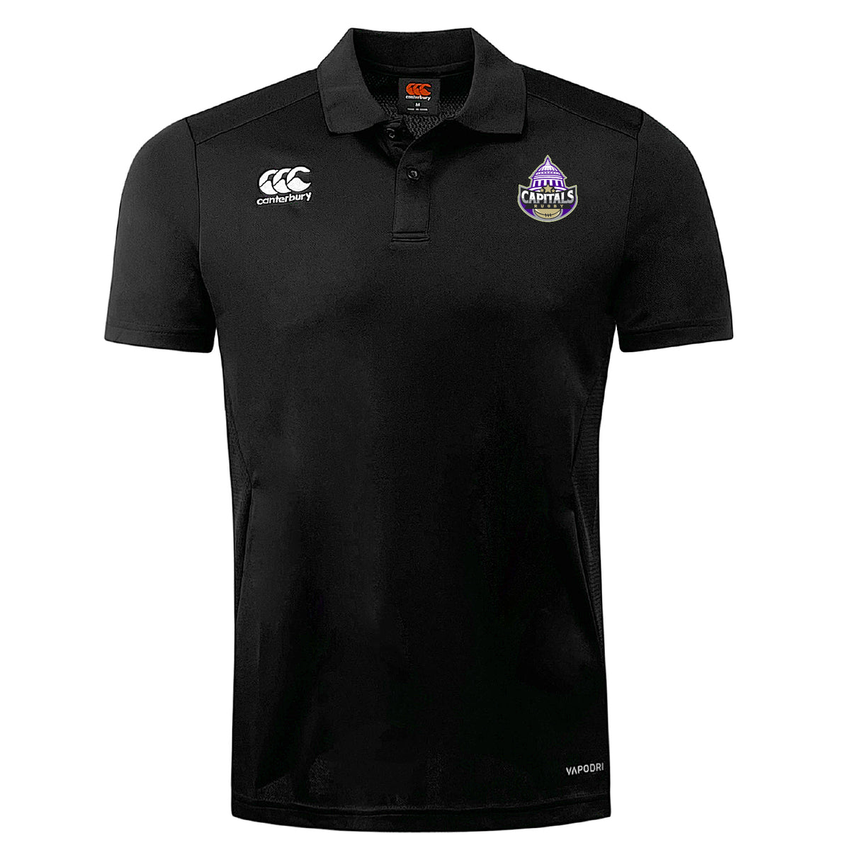 The Capitals Rugby NC Club Dry Polo by EMB Canterbury is a black short-sleeve polo with Vapodri Technology, featuring the Canterbury logo on the right chest and a purple Capitals team crest on the left.