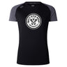 The White River Rugby Football Club Women's Elite Training Tee by WRS Canterbury is a black and gray short-sleeve, lightweight top with a circular "White River Rugby Indianapolis" logo—ideal for elite performance workouts.