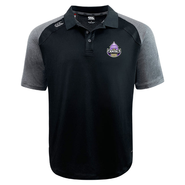 The Capitals Rugby NC Elite Polo by EMB Canterbury is a black and grey short-sleeve polo made with Vapodri fabric, featuring a "Canberra Capitals" logo on the chest and a "Canterbury" logo on the right shoulder.
