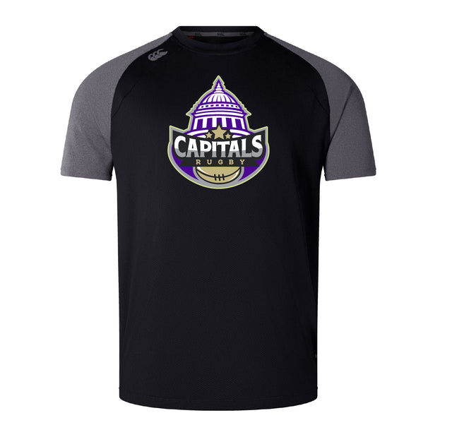 The Capitals Rugby NC Elite Training Tee by WRS Canterbury features a purple, white, and gold "Capitals Rugby" dome logo on black and dark gray Vapodri fabric for lightweight durability and performance.
