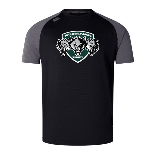 The Woodlands Youth Wolfpack Elite Training Tee by WRS Canterbury is a black/gray short-sleeve top with three wolf heads and a "Woodlands Rugby" logo, made from lightweight Vapodri fabric for comfort and performance.
