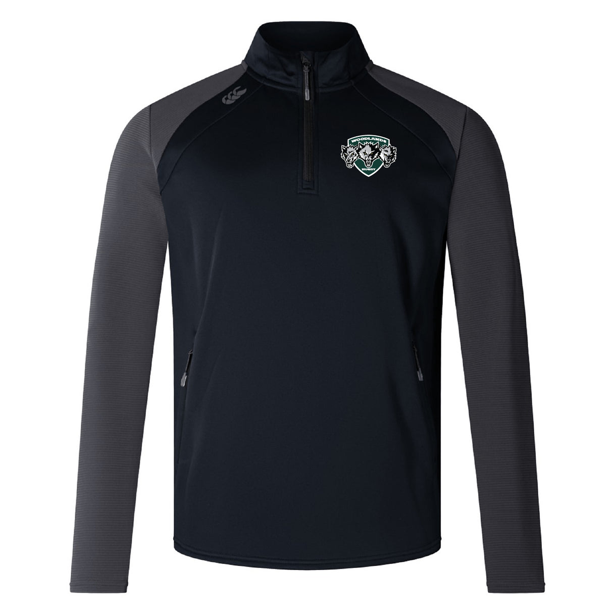 The Woodlands Youth Wolfpack Elite 1/4 Zip Top by EMB Canterbury features black and gray colors, long sleeves, zippered pockets, an embroidered crest logo on the left chest, and a sleek performance quarter zip design.
