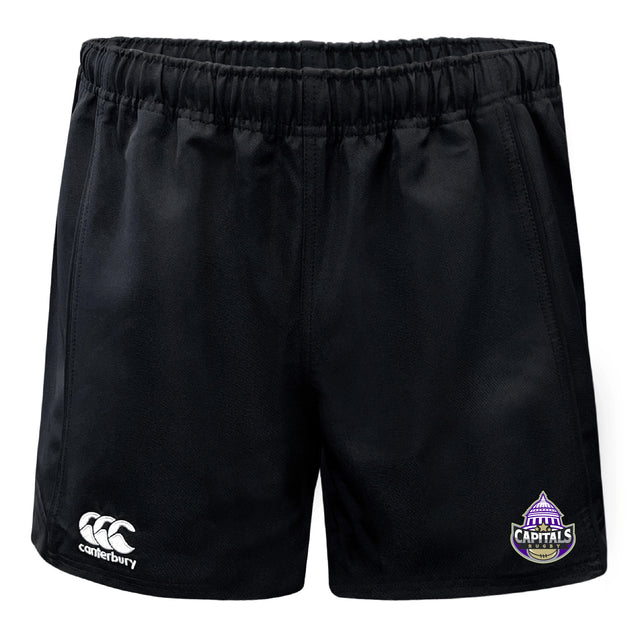 The Capitals Rugby NC Professional Polyester Rugby Short by EMB Canterbury features black fabric, pockets, an elastic waistband, a white Canterbury logo on one leg, and a purple Capitals team logo on the other.