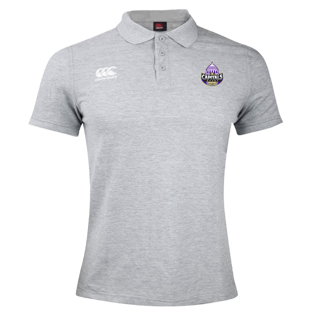 The Capitals Rugby NC Waimak Polo by EMB Canterbury is a light gray collared shirt with the CCC Waimak Rugby Polo logo on the right chest and a Capitals team logo on the left—ideal for rugby fans.
