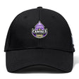 The Capitals Rugby NC Flexfit Drill Cap by EMB Canterbury is a black cap with a purple and white embroidered Capitals Rugby logo, featuring a capitol dome and rugby ball on the front.