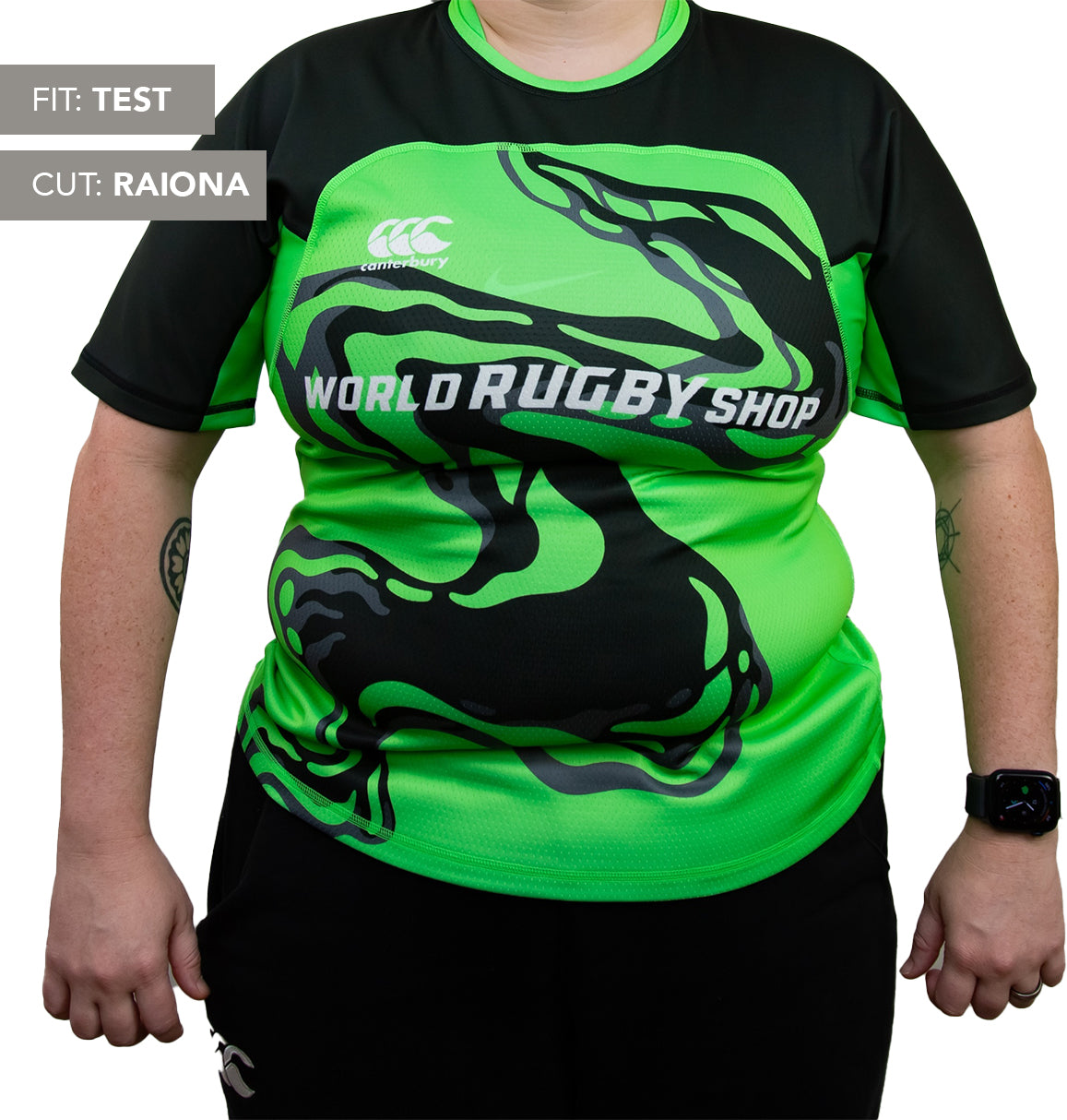 A person is wearing a green and black Teamatical Canterbury Elite Full Custom Sublimated Jersey - Women's with an abstract black design; labels read "Fit: Test" and "Cut: Raiona.