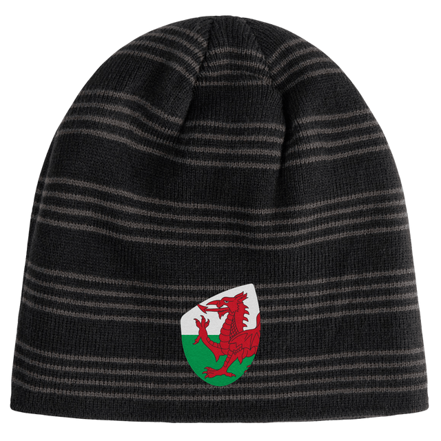 The Wales Shield Beanie by EMB Canterbury is a black and gray striped beanie showcasing a fierce red dragon emblem on a classic white and green shield.