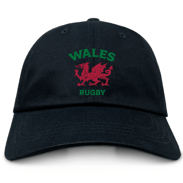 The EMB S&S Activewear Nations of Rugby Wales Dad Cap is a black cap with "WALES RUGBY" and a bold red Welsh dragon emblem on the front—perfect for rugby fans.