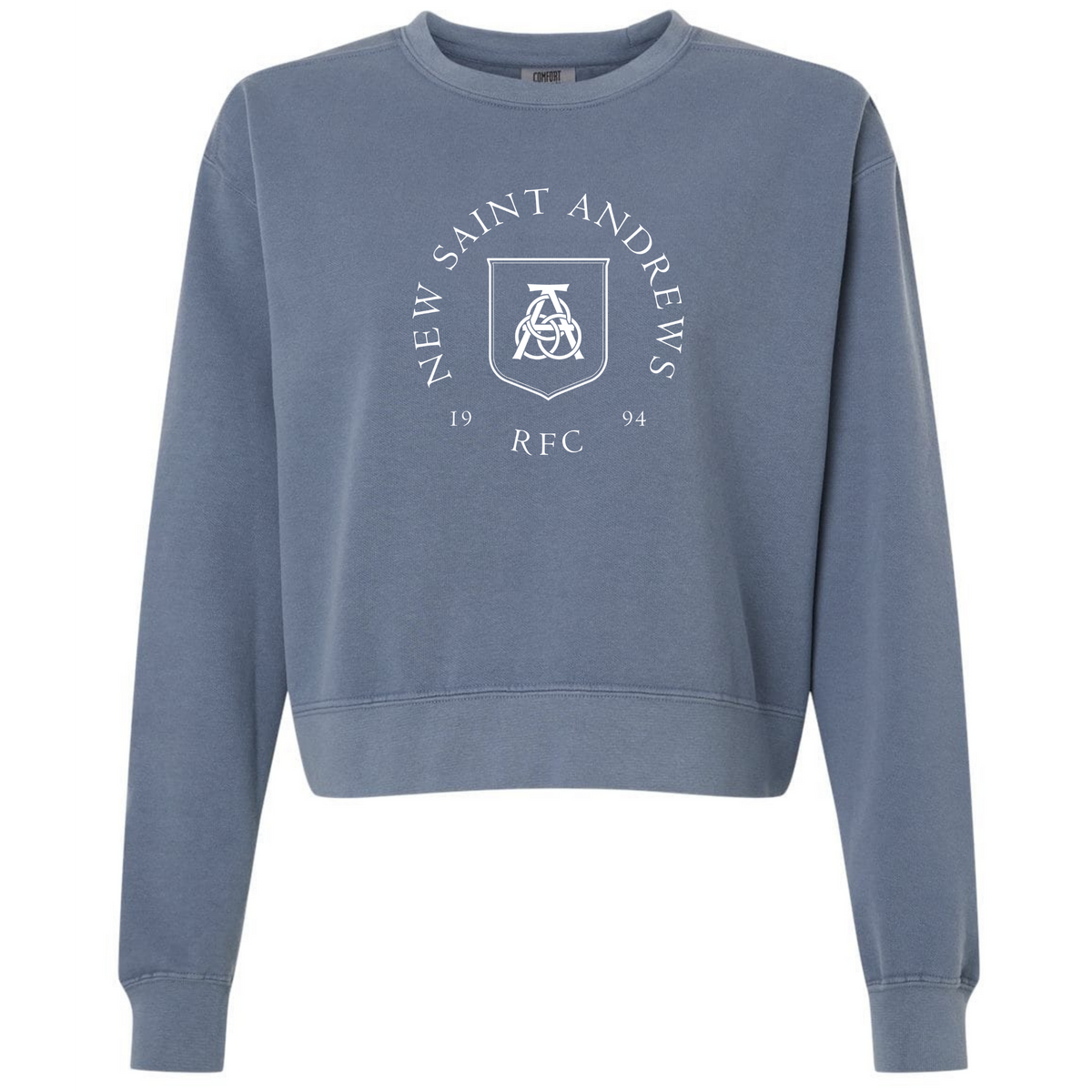 Introducing the New Saint Andrews College Women’s Garment-Dyed Mid-Length Crewneck Sweatshirt by EMB S&S Activewear—a blue heavyweight fleece sweatshirt designed with a mid-length silhouette. This stylish and comfortable everyday crewneck features “New Saint Andrews RFC 1994” and a white crest printed on the front.