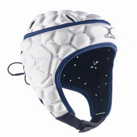 The Gilbert XP 250 Rugby Headguard features ventilation holes, a secure chin strap, and the Gilbert logo—offering comfort and protection in white and navy blue.
