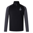The Austin Huns Youth Rugby Elite First Layer by EMB Canterbury is a black and dark gray long-sleeve quarter-zip top with "Huns Youth Rugby" logo on the chest, a white shoulder logo, and VapoDri tech for comfort during play.