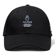 The Austin Huns Youth Rugby Flexfit Drill Cap by EMB Canterbury features a black design with the "Huns Youth Rugby" logo, including a Viking helmet and beard, and has a classic curved brim style.