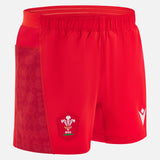 The Wales 25/26 Matchday Home Shorts by Macron are red men's rugby shorts with the Welsh Rugby Union logo on the front left leg, a patterned side panel, and an elastic waistband.