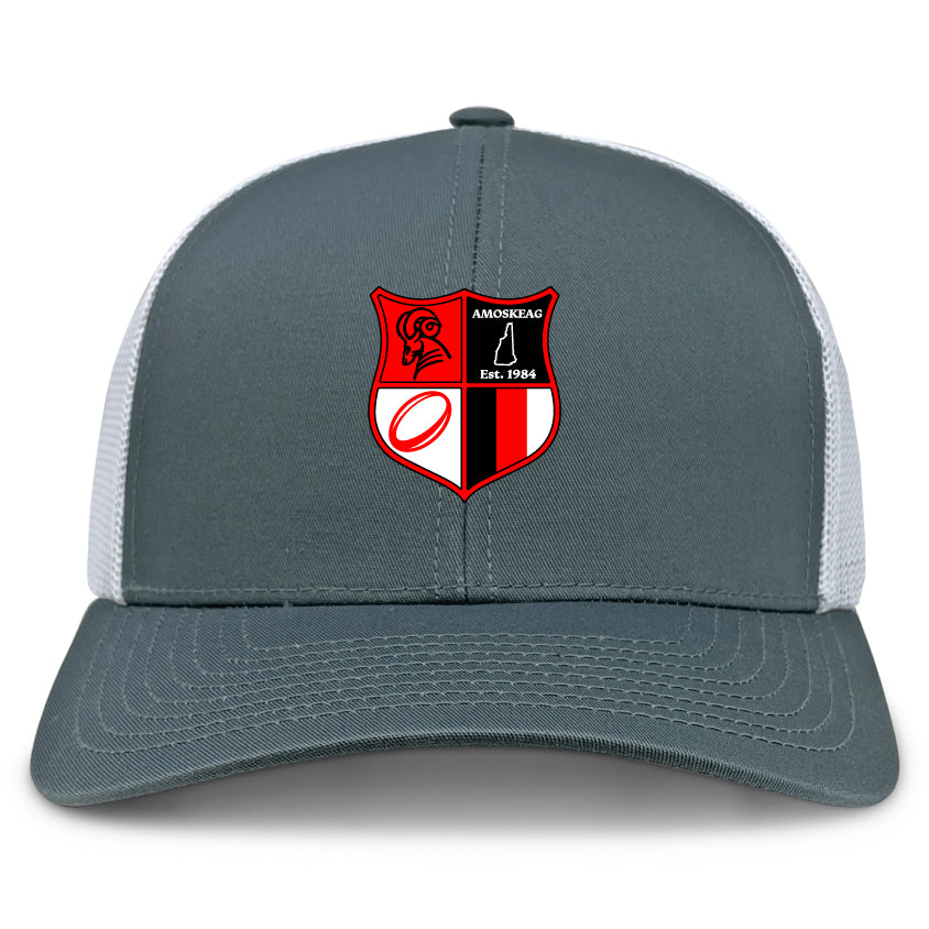 The Amoskeag Rugby Club Retro Trucker Cap by EMB S&S Activewear features an embroidered shield logo with red, black, and white symbols plus "AMOSKEAG Est. 1984" on the front and has a snapback closure for adjustable fit.