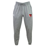 The Amoskeag Rugby Club Leisure Sweatpant by EMB Canterbury is made from recycled polyester fleece and features a white logo on the left pocket, a red, black, and white shield emblem on the right thigh, and a drawstring waist for adjustable comfort.