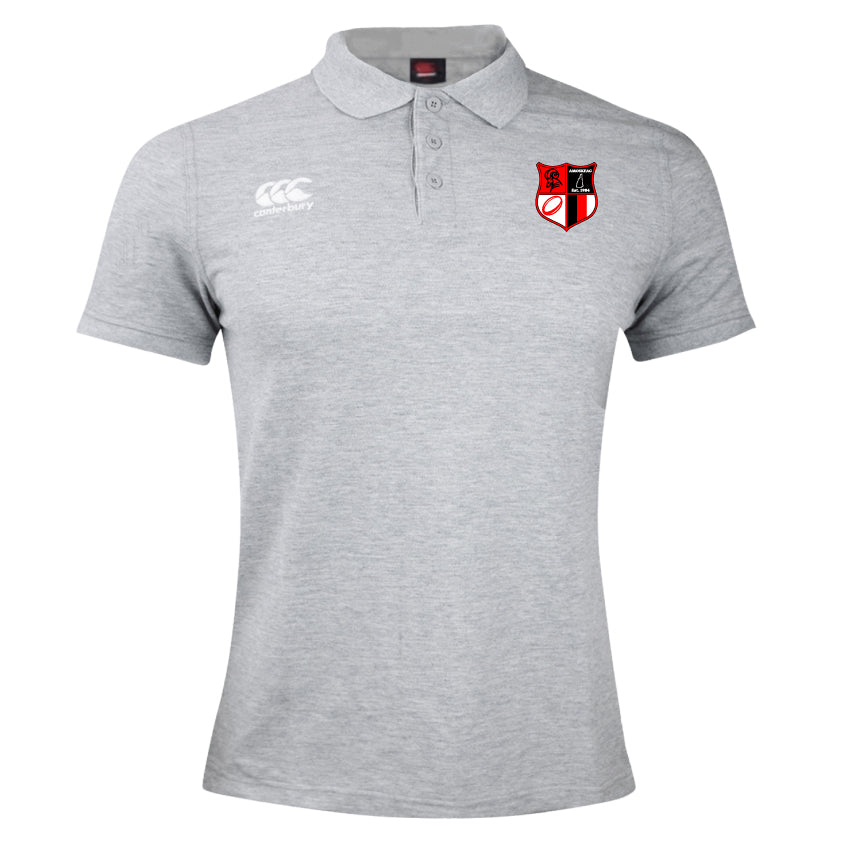 The Amoskeag Rugby Club Waimak Polo by EMB Canterbury is a gray rugby shirt with a collar, featuring Canterbury logos on the left chest and right sleeve, made from a comfortable cotton-polyester blend.