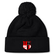 The Amoskeag Rugby Club Pom Pom Beanie by EMB Canterbury features a black design with a red and black embroidered shield patch. Its fleece-lined interior offers warmth on chilly days.