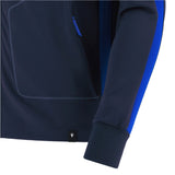 Close-up of the sleeve and side of the Italy 25/26 Anthem Jacket by Macron, featuring a blue stripe along the arm and a small black logo tag near the bottom hem.
