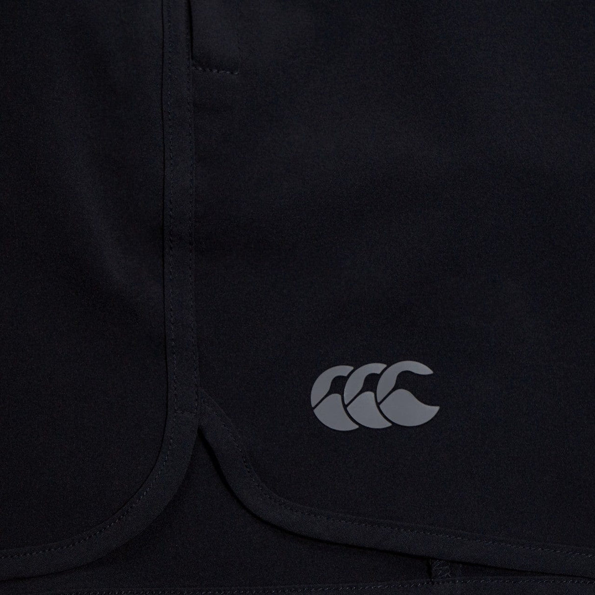 Close-up of a dark Canterbury Elite Woven gym short with a white Canterbury logo on the lower right side.