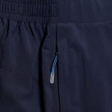 Close-up of a dark navy Canterbury Elite Woven Short fabric with a detailed view of zippered pockets and a blue zipper pull.