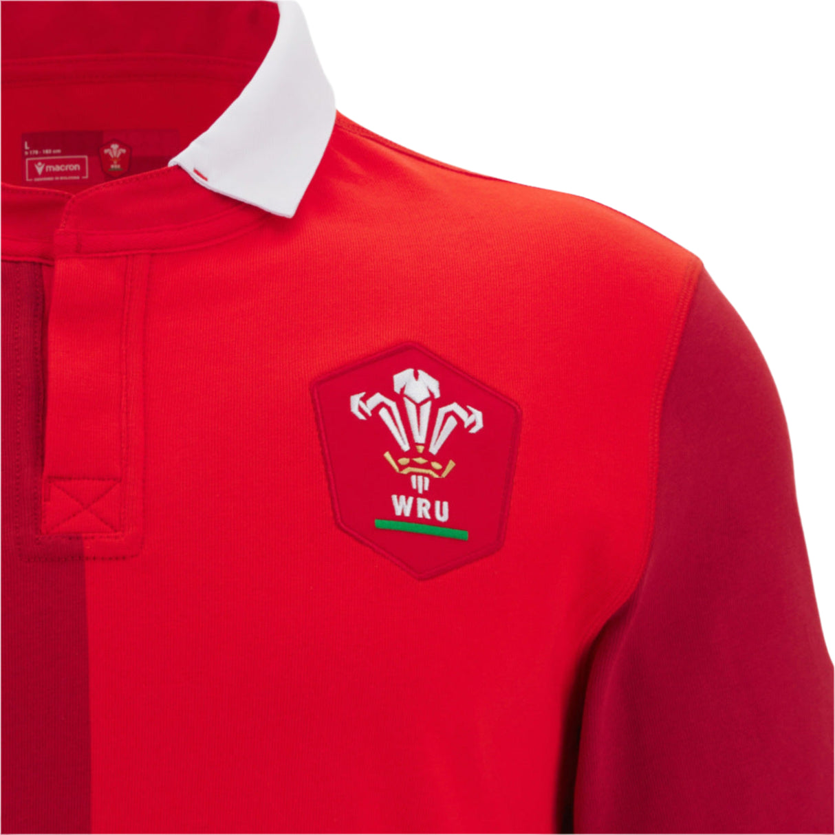 The Wales 25/26 Replica Home Cotton Jersey by Macron features a classic white collar and WRU logo—a timeless fan shirt perfect for any supporter.