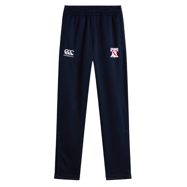 The Philly Whitemarsh RFC Stretch Tapered Pant by EMB Canterbury features an elastic waistband, Canterbury logo on the left, and a red and white "T" on the right thigh. These quick-dry navy pants deliver comfort and style for workouts.