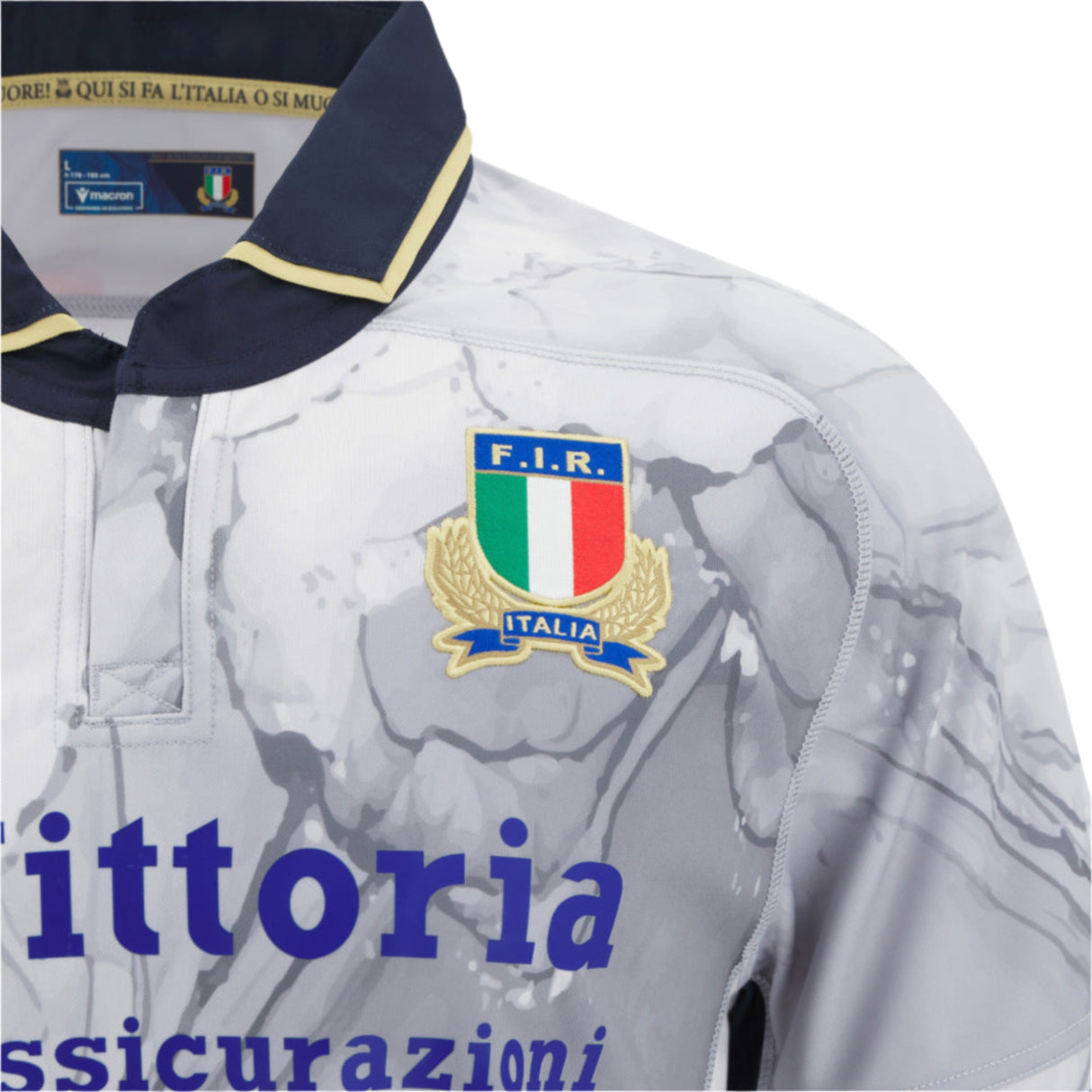 Close-up of the Italy 25/26 Replica Away Jersey by Macron, featuring the F.I.R. crest, marble-patterned fabric, and partial sponsor text on the front.