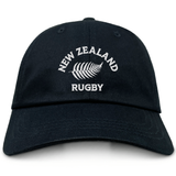 The EMB S&S Activewear Nations of Rugby New Zealand Dad Cap is a black cotton twill hat with "New Zealand Rugby" and a white embroidered silver fern logo on the front—a must-have classic for dedicated rugby fans.