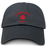 The Nations of Rugby Canada Rugby Dad Cap by EMB S&S Activewear is a black hat featuring red "CANADA RUGBY" embroidery and a red maple leaf on the front—perfect for dedicated rugby fans.