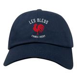 The Les Bleus France Rugby Dad Cap by EMB S&S Activewear features "LES BLEUS FRANCE RUGBY" and a red rooster logo on navy blue cotton twill, offering classic dad cap style.