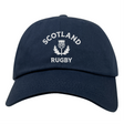 The EMB S&S Activewear Nations of Rugby Scotland Dad Cap features navy blue cotton twill and front white "SCOTLAND RUGBY" with thistle embroidery—a classic hat for rugby fans.