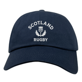 The EMB S&S Activewear Nations of Rugby Scotland Dad Cap features navy blue cotton twill and front white "SCOTLAND RUGBY" with thistle embroidery—a classic hat for rugby fans.