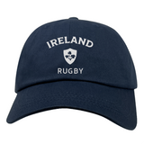 The Nations of Rugby Ireland Dad Cap by EMB S&S Activewear is a navy cotton twill cap with "IRELAND RUGBY" and a white shamrock emblem—perfect for showing team pride.